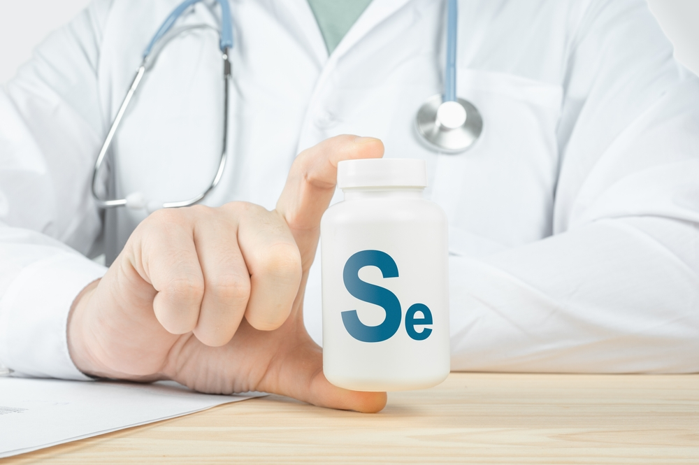 doctor holding bottle of selenium supplements